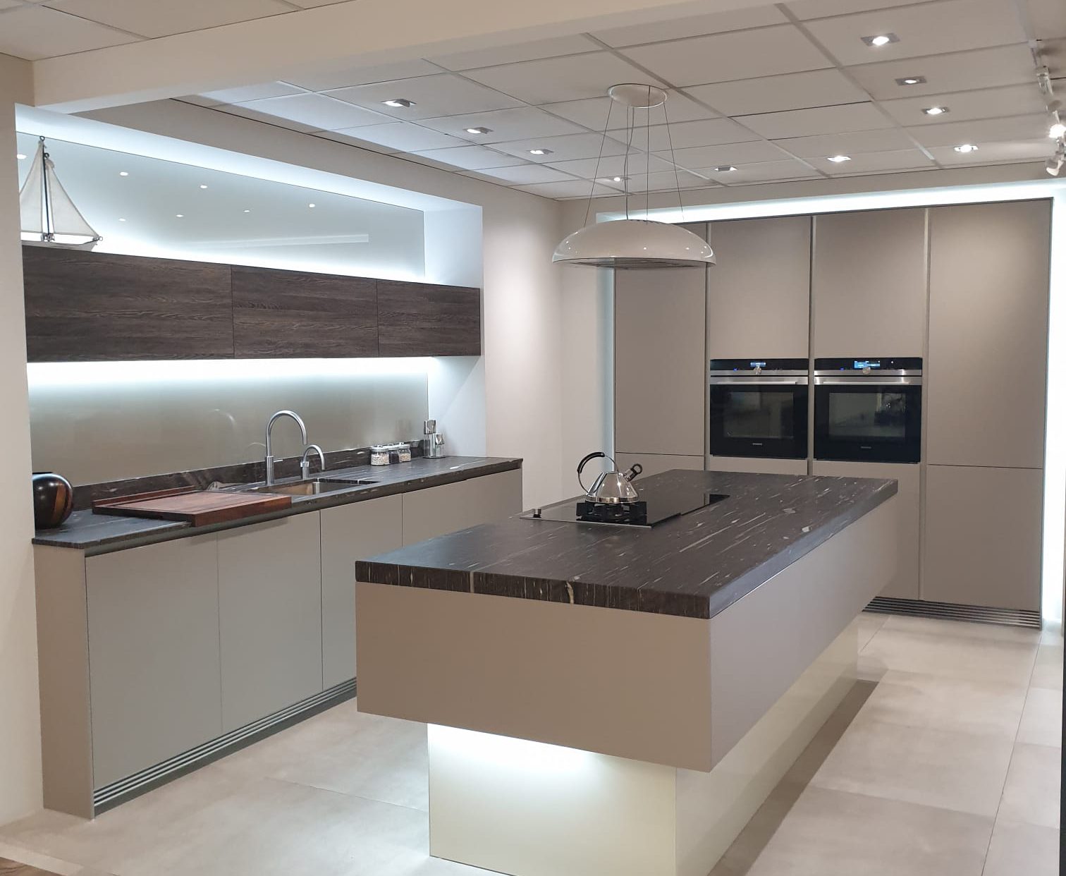 Kitchen with an island and LED backlighting around cabinets
